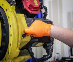 Photo of a fanuc robot join being gresaed