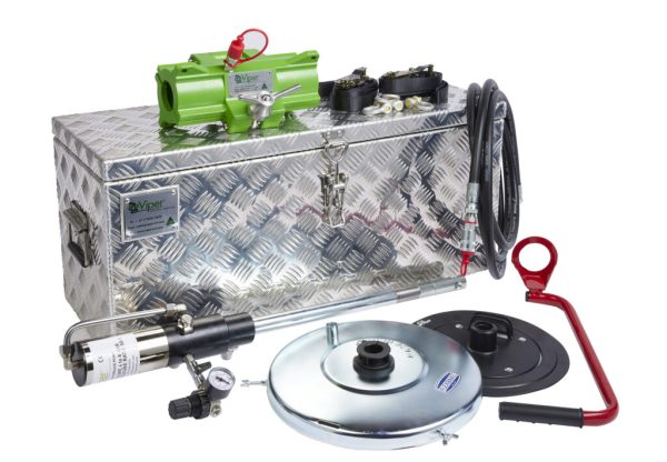Portable hydraulic pump kit with green pump on a diamond-plate metal toolbox, hoses and fittings nearby.