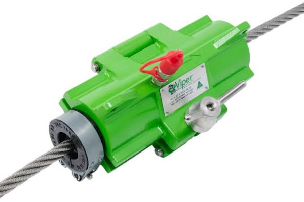 Green inline wire rope hoist labeled 'Viper' clamped onto a steel cable with a red safety lever, used to grip and drive the rope for lifting or pulling.
